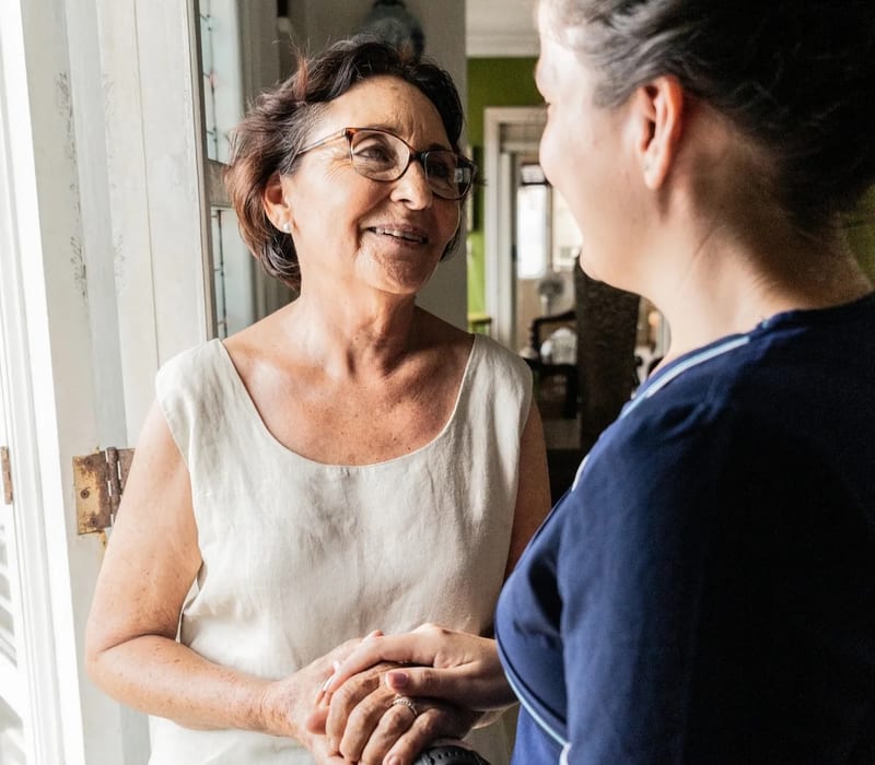 A caregiver and resident sharing a warm moment at home