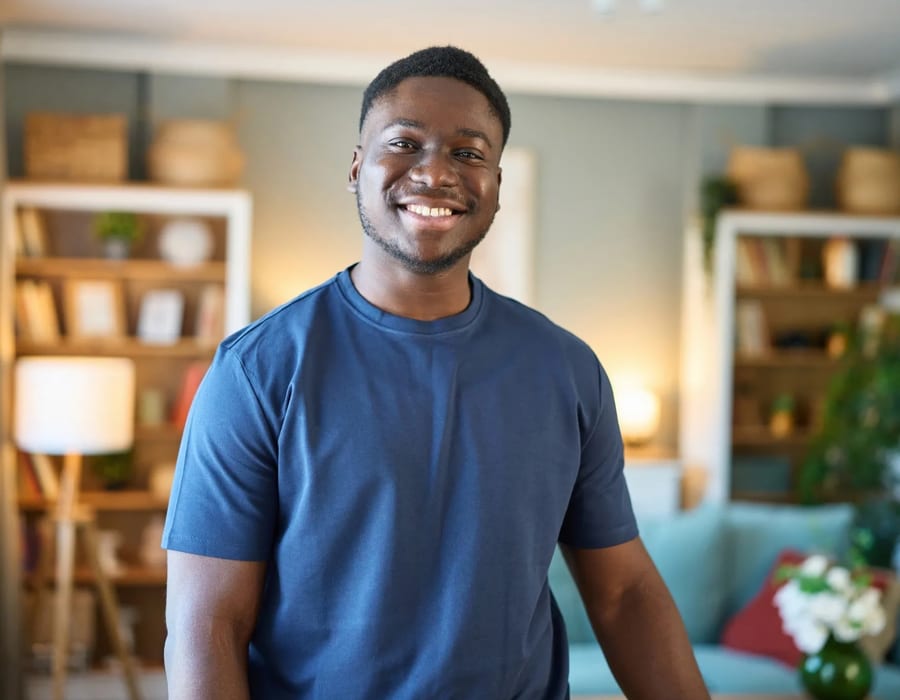 Young adult smiling confidently in a warm home living room